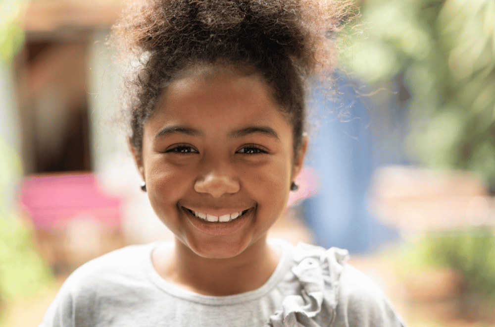 young girl smiling outdoors