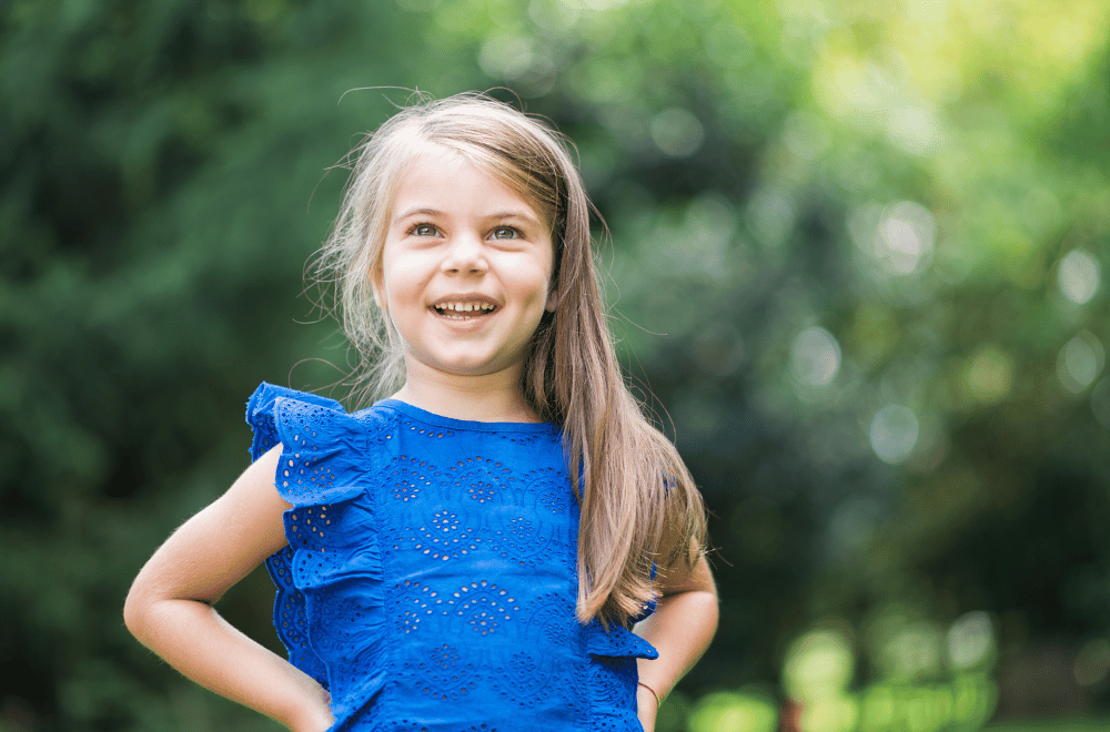 little girl outside smiling