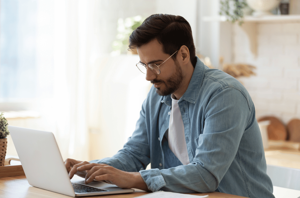 a man sitting and looking at a computer